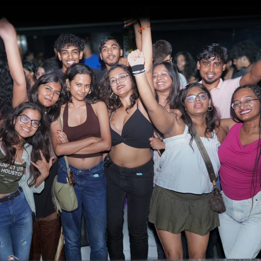 College friends grouped together for a photo on the dance floor at Gravity