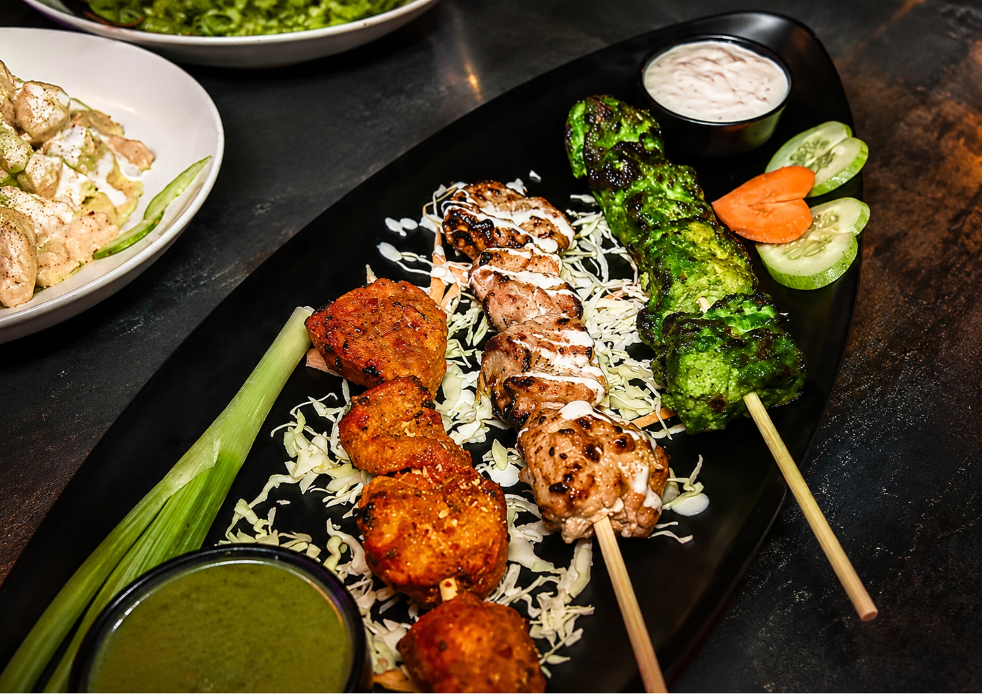 Platter of grilled chicken skewers, fritters and chutneys served at Gravity in Puducherry