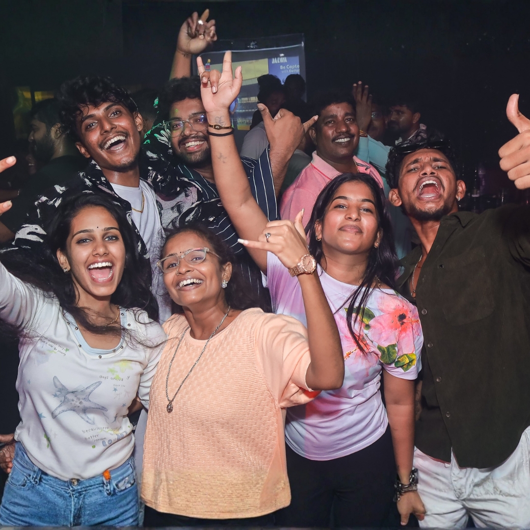 Friends cheering with hands in the air during a night out at Gravity